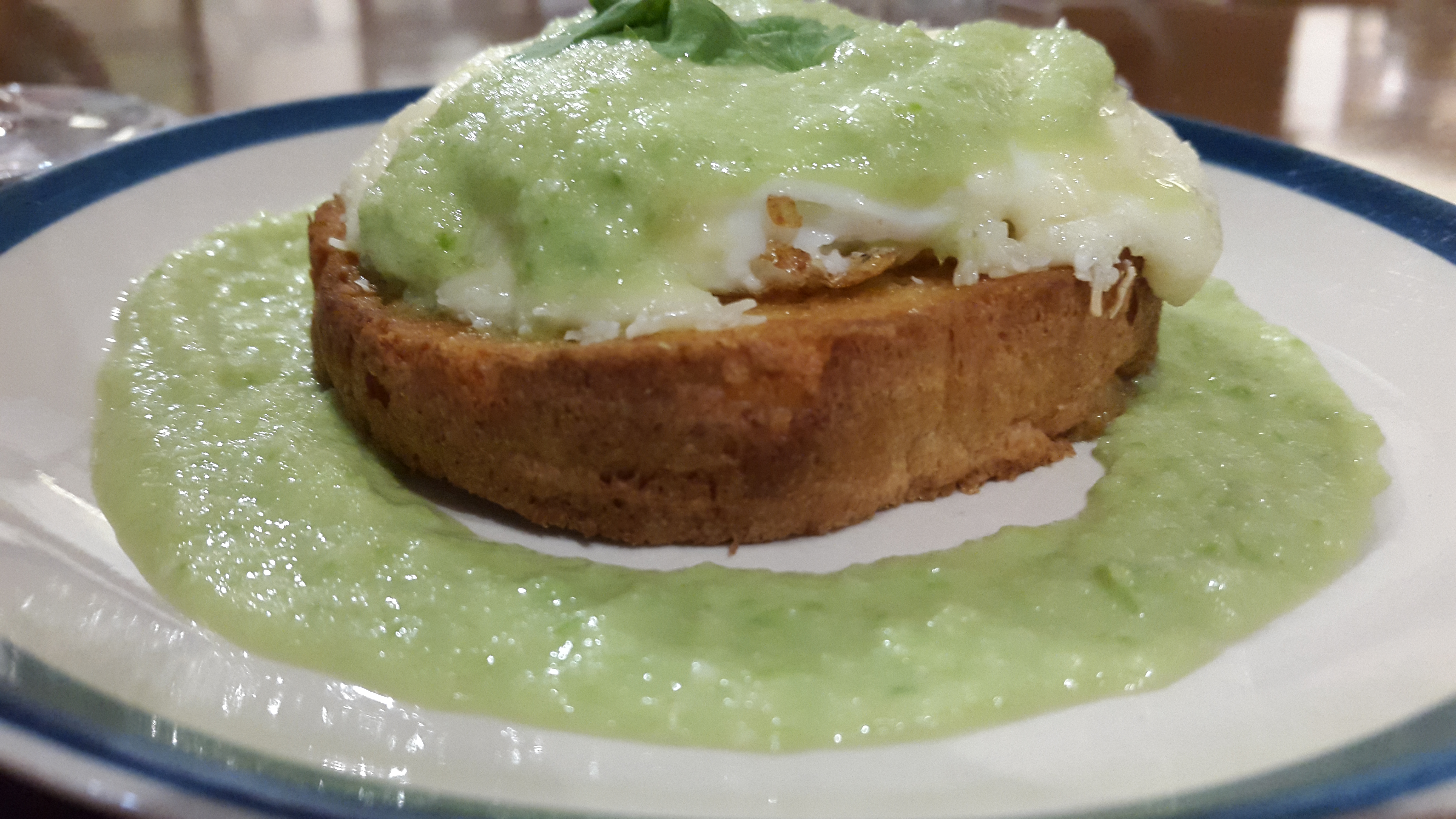 Eggs Kejriwal Bombay Canteen style. Beautifully poached egg in a strangely compelling green chutney